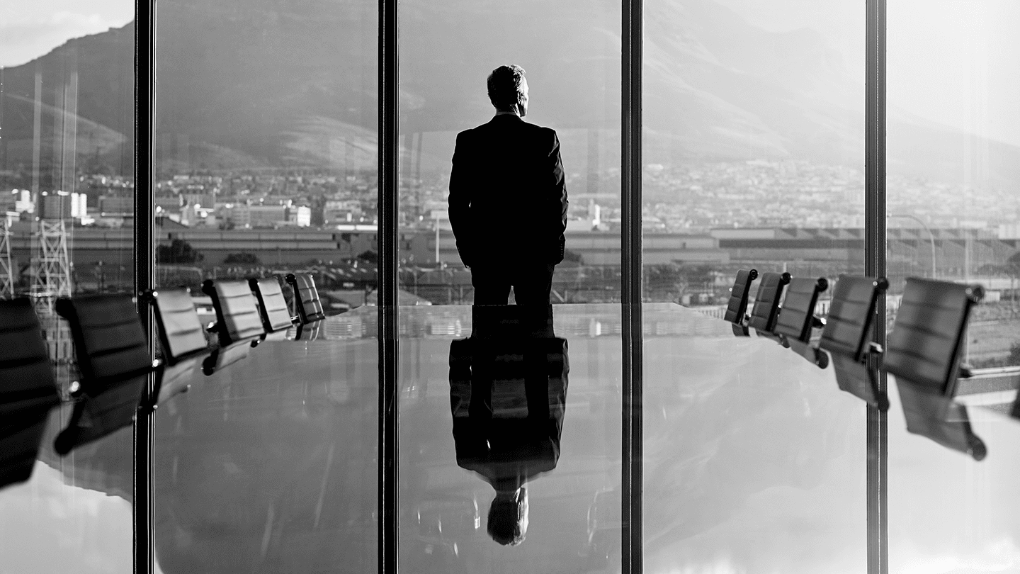 Lone man in empty board room