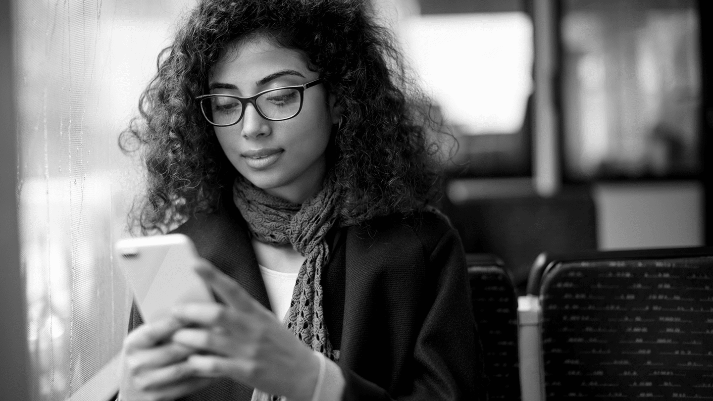 Woman with glasses looking at phone