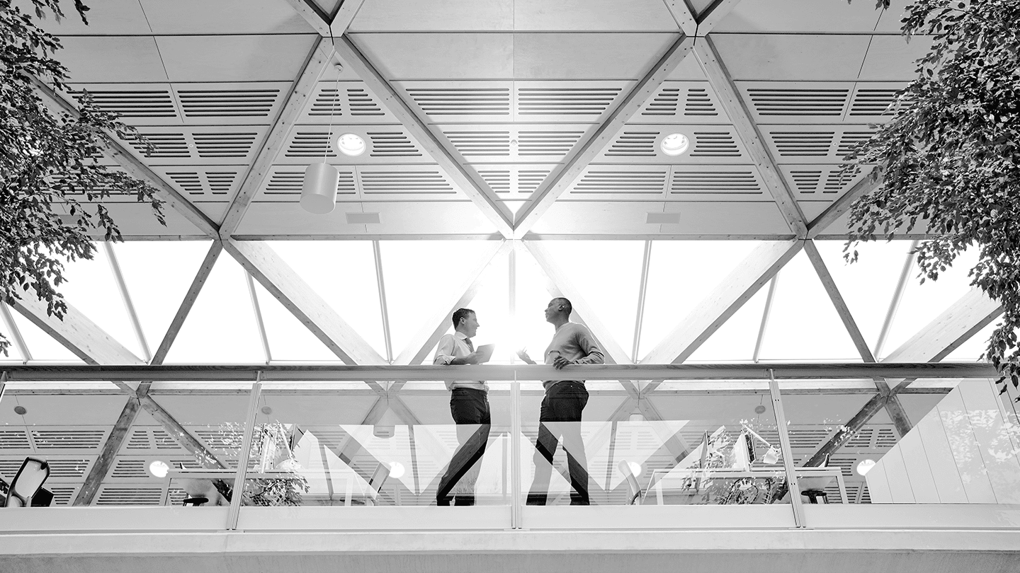 Two people talking on balcony