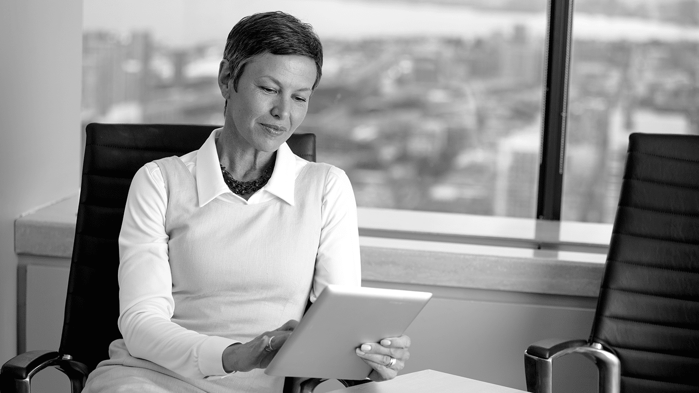 Woman typing on tablet