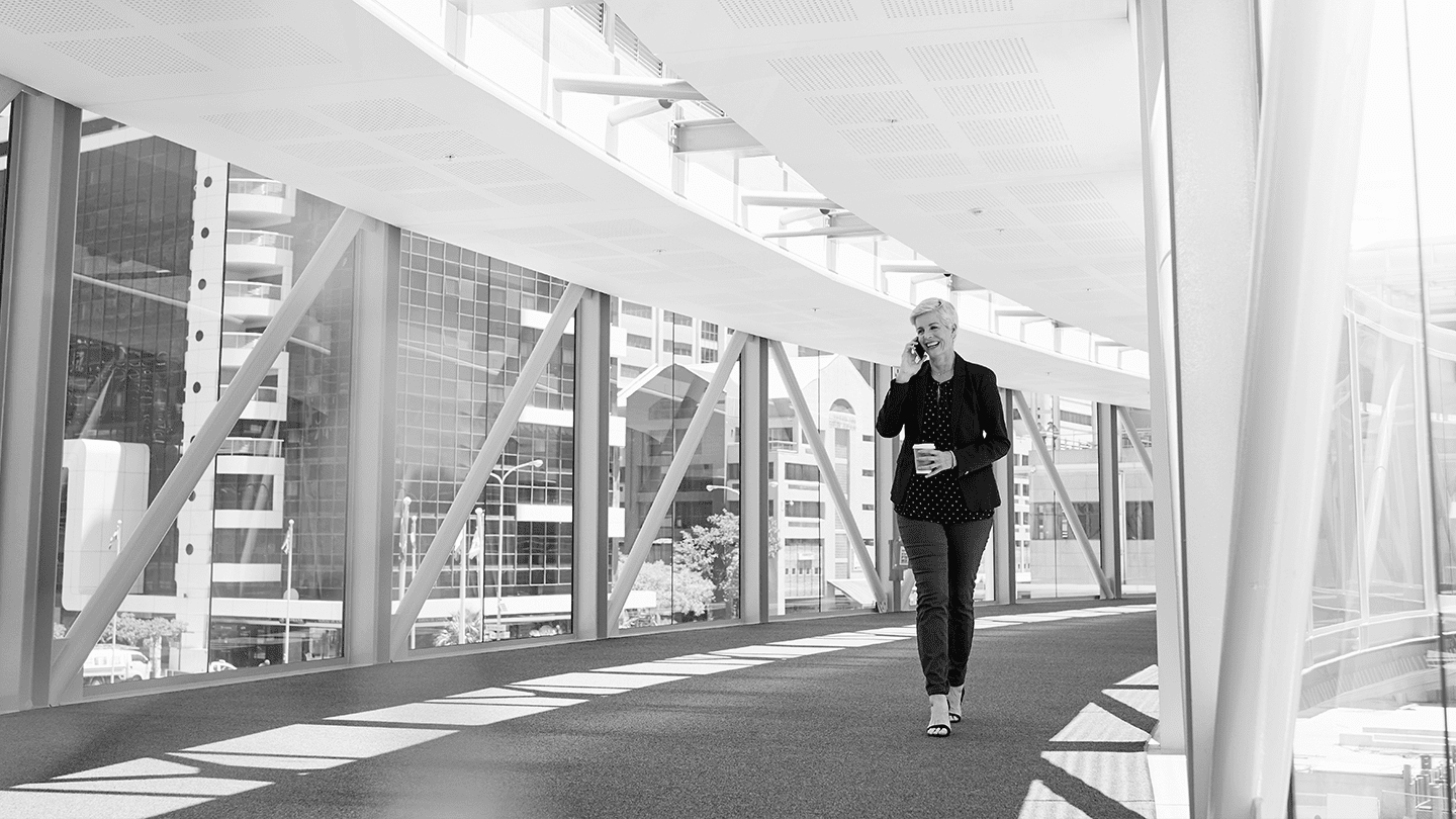 woman smiling and talking on a phone