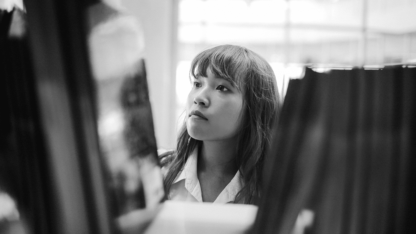 Woman looking at bookshelf